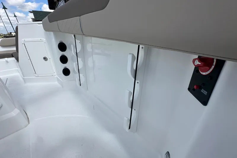 Slide: The Image of 2027 Tahoe 2150 CC boat interior with storage compartments and control panel. - 27