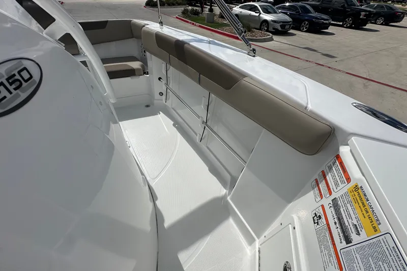 Slide: The Image of 2027 Tahoe 2150 CC boat interior with seating and safety labels. - 23