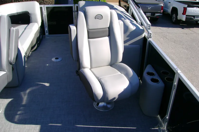 Slide: The Image of 2027 Sun Tracker Party Barge 22 XP3 interior with plush seating and cup holders. - 13