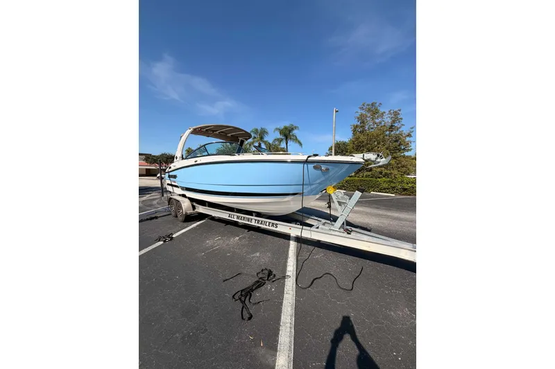 Slide: The Image of 2024 MONTERY 278ss boat on trailer under clear blue sky. - 25