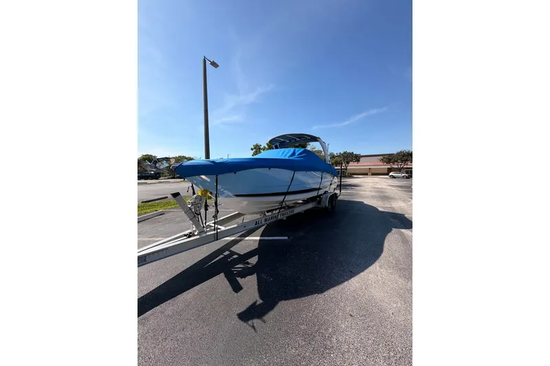 Slide: The Image of 2024 MONTERY 278ss boat on trailer with blue cover in parking lot. - 26