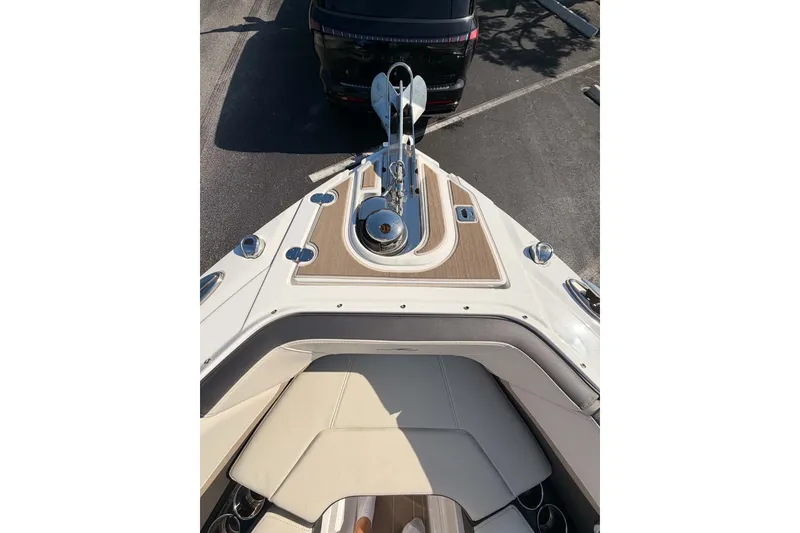 Slide: The Image of 2024 MONTERY 278ss boat bow with anchor and seating, parked in a lot. - 13