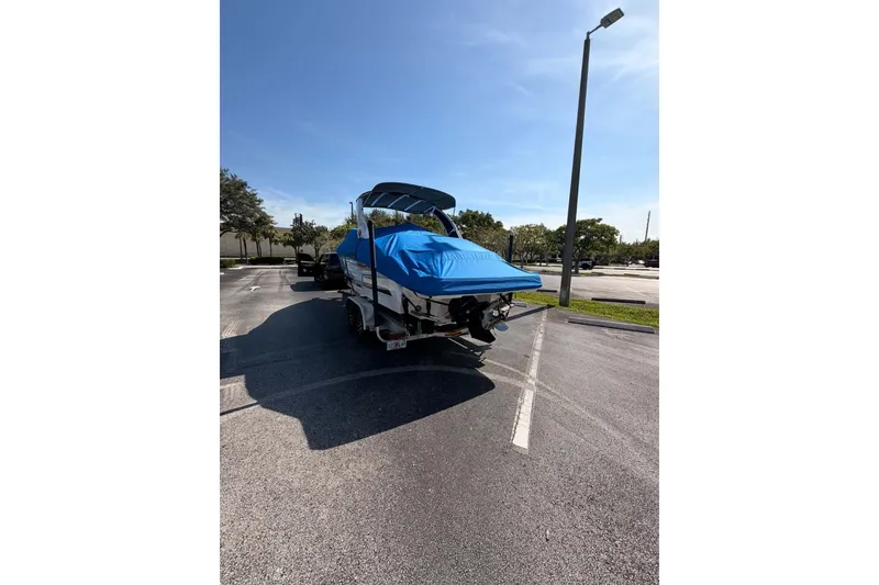 Slide: The Image of 2024 MONTERY 278ss boat with blue cover in a parking lot. - 27