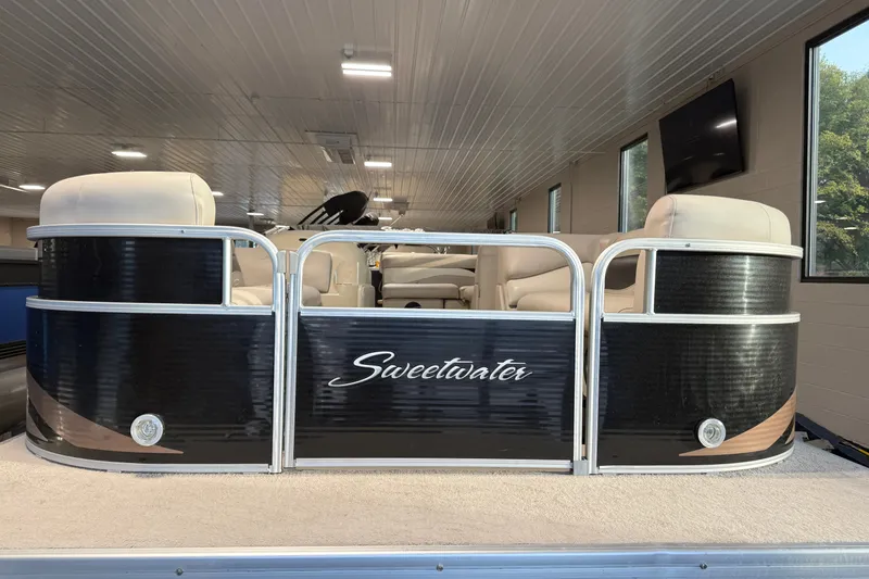 Slide: The Image of 2014 Sweetwater 2286 pontoon boat with sleek black exterior and comfortable seating. - 13