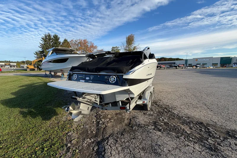 Slide: The Image of 2020 Regal LS4 boat on trailer in parking lot under blue sky. - 19
