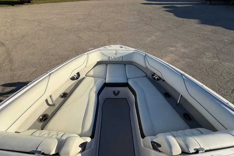 Slide: The Image of 2020 Regal LS4 boat interior with white seating and cup holders. - 14