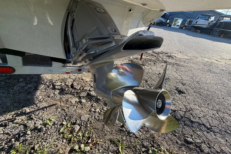 Slide: The Image of 2020 Regal LS4 boat propeller and outdrive on a gravel surface. - 20