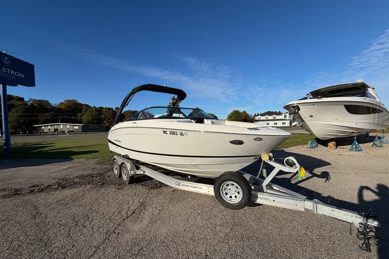 The Image of 2020 Regal LS4 boat on trailer under clear blue sky at dealership. - 0