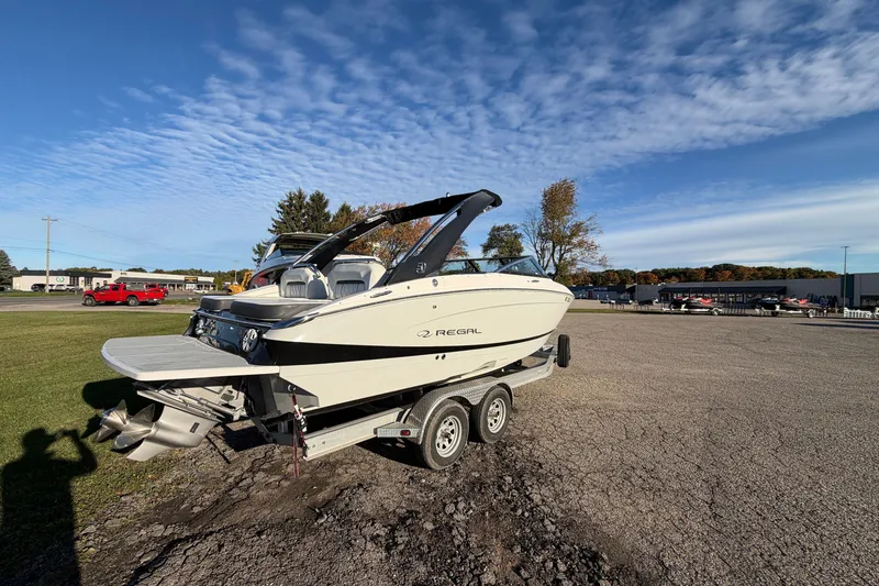 Slide: The Image of 2020 Regal LS4 boat on trailer under clear blue sky. - 15