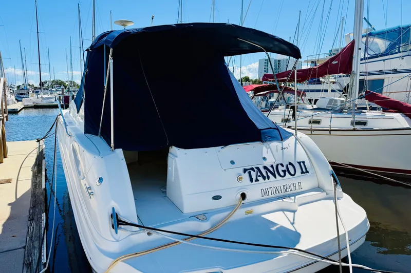 Slide: The Image of 2005 Sea Ray 340 Sundancer docked at marina, covered with navy blue canopy. - 6