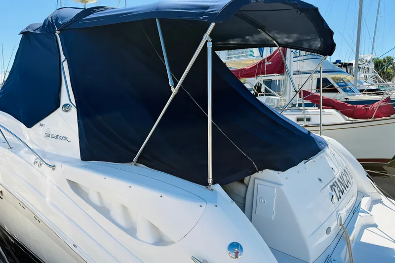 Slide: The Image of 2005 Sea Ray 340 Sundancer yacht with blue canopy docked at marina. - 3