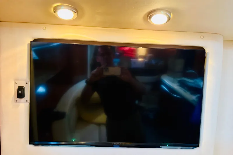 Slide: The Image of Flat-screen TV inside 2005 Sea Ray 340 Sundancer yacht cabin, illuminated by overhead lights. - 43