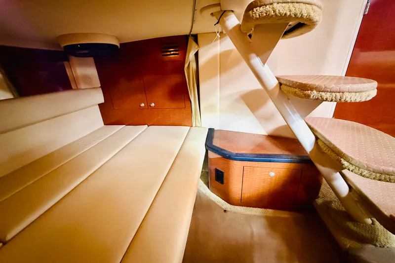 Slide: The Image of Interior cabin of 2005 Sea Ray 340 Sundancer with beige seating and wooden accents. - 45