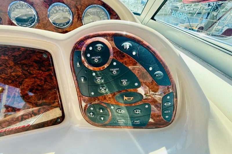 Slide: The Image of Dashboard controls of a 2005 Sea Ray 340 Sundancer boat with wood finish. - 18