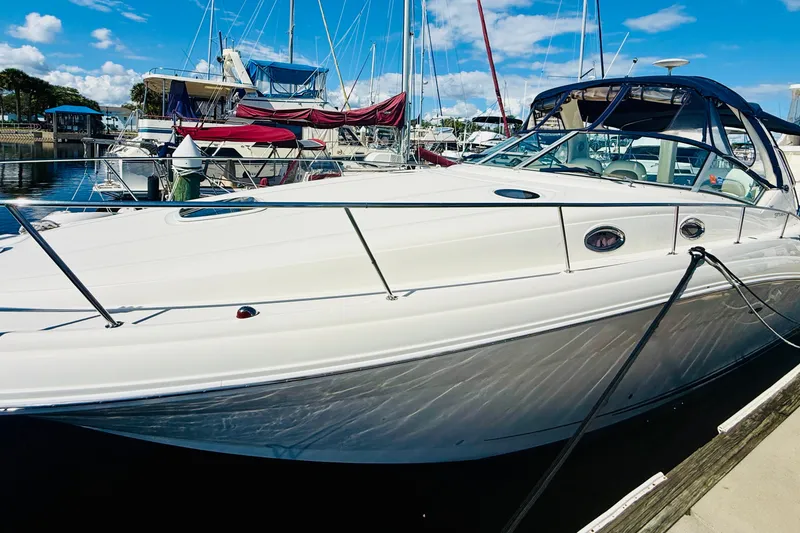 Slide: The Image of 2005 Sea Ray 340 Sundancer yacht docked at marina under clear blue sky. - 4