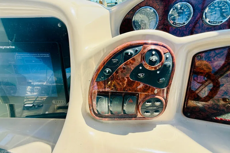 Slide: The Image of Control panel of a 2005 Sea Ray 340 Sundancer boat with gauges and navigation screen. - 16