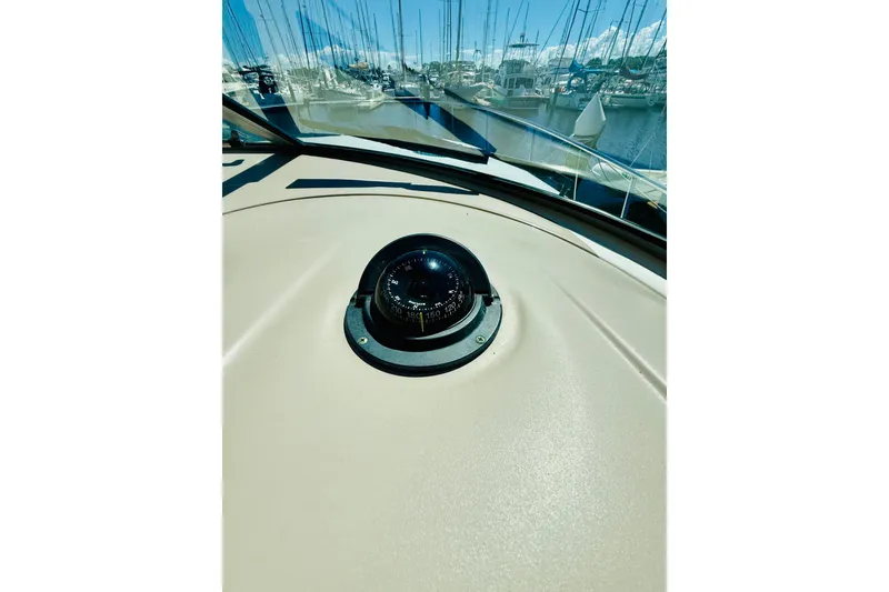 Slide: The Image of Compass on 2005 Sea Ray 340 Sundancer boat dashboard, marina view in background. - 14