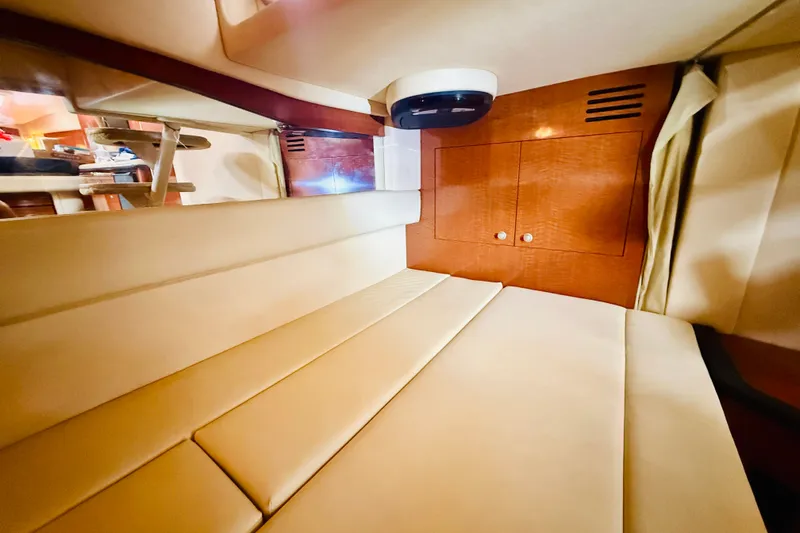 Slide: The Image of Interior cabin of 2005 Sea Ray 340 Sundancer with beige seating and wooden cabinetry. - 46