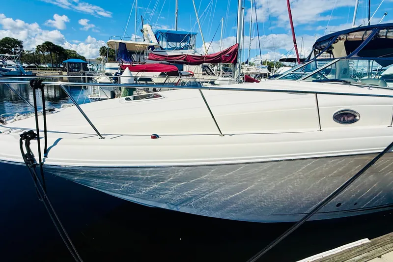 Slide: The Image of 2005 Sea Ray 340 Sundancer yacht docked at marina under blue sky. - 8
