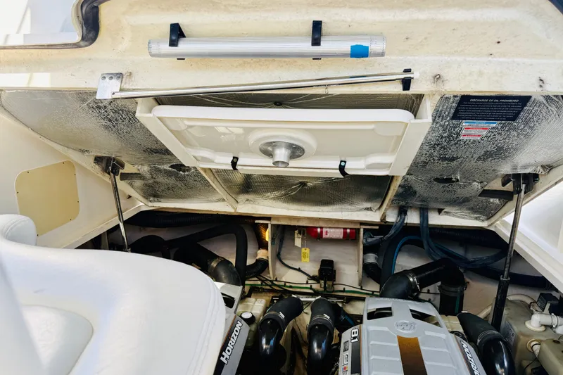 Slide: The Image of Engine compartment of a 2005 Sea Ray 340 Sundancer boat, showcasing mechanical components. - 73