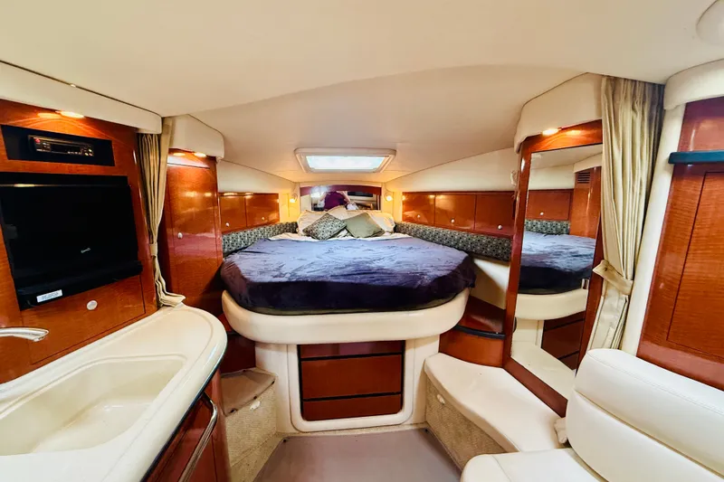 Slide: The Image of Luxurious interior of 2005 Sea Ray 340 Sundancer yacht with cozy bed and elegant wood finishes. - 64