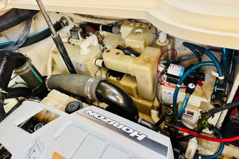 Slide: The Image of Engine compartment of a 2005 Sea Ray 340 Sundancer boat, showcasing mechanical components. - 70