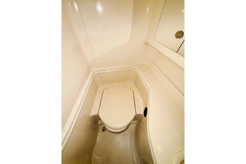 Slide: The Image of 2005 Sea Ray 340 Sundancer bathroom interior with compact toilet and sleek design. - 52