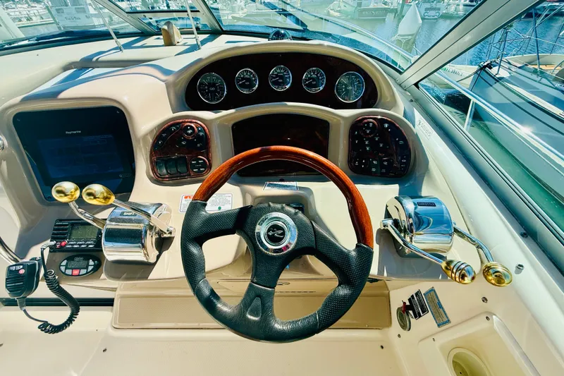 Slide: The Image of Cockpit of 2005 Sea Ray 340 Sundancer with steering wheel and control panel. - 15