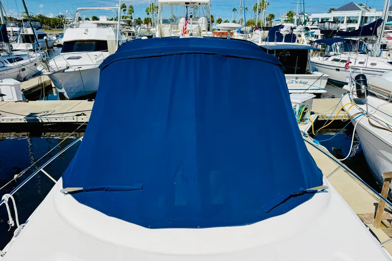 Slide: The Image of 2005 Sea Ray 340 Sundancer with blue cover docked at marina. - 35