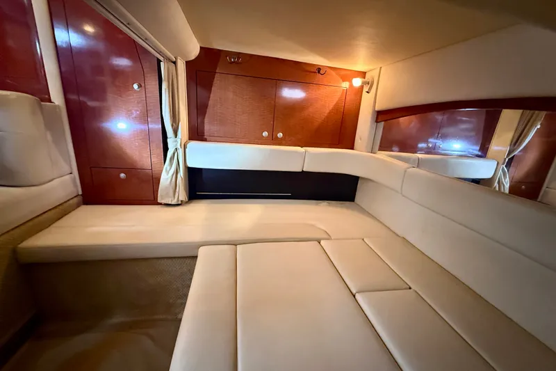 Slide: The Image of Luxurious interior of 2005 Sea Ray 340 Sundancer with plush seating and wooden cabinetry. - 44