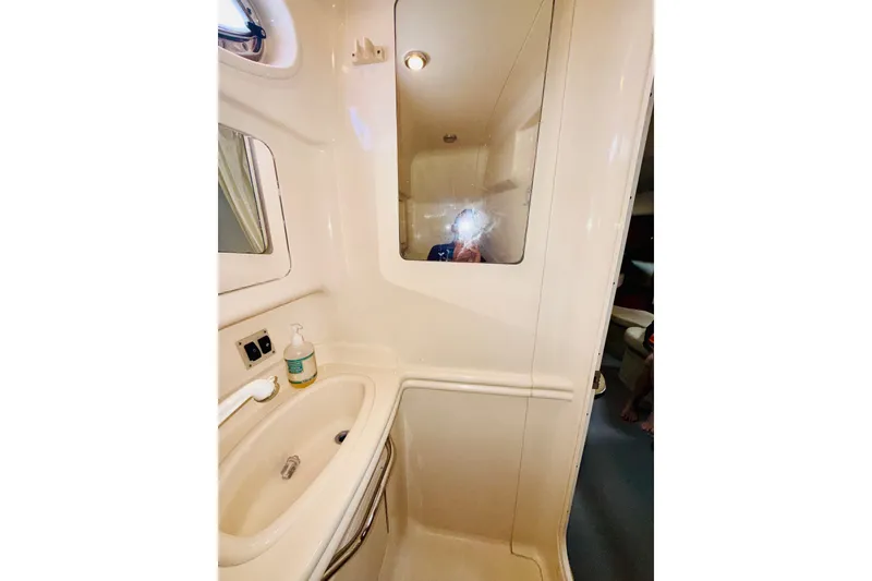 Slide: The Image of Bathroom interior of 2005 Sea Ray 340 Sundancer yacht, featuring sink and mirror. - 51