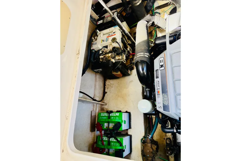 Slide: The Image of Engine compartment of a 2005 Sea Ray 340 Sundancer with visible batteries and components. - 69