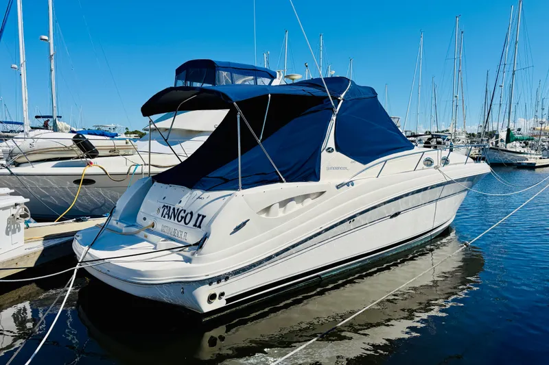 Slide: The Image of 2005 Sea Ray 340 Sundancer yacht docked at marina with blue canopy. - 1