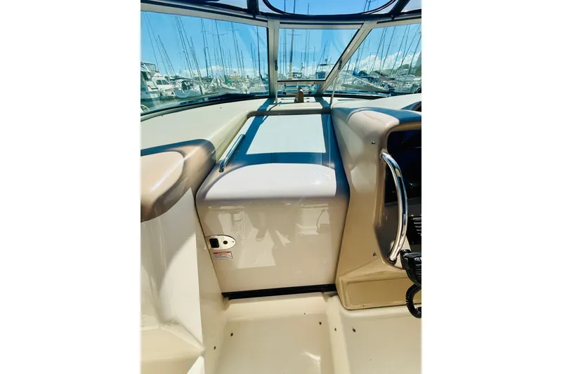 Slide: The Image of 2005 Sea Ray 340 Sundancer cockpit with marina view through windshield. - 13