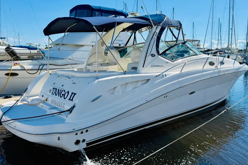 The Image of 2005 Sea Ray 340 Sundancer yacht docked at marina under clear blue sky. - 0