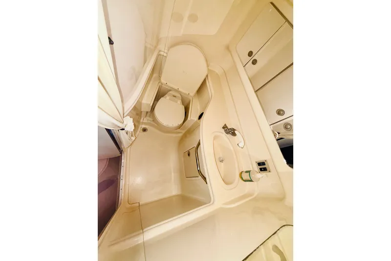 Slide: The Image of 2005 Sea Ray 340 Sundancer bathroom with sink, toilet, and storage cabinets. - 53