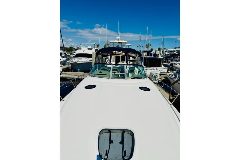 Slide: The Image of 2005 Sea Ray 340 Sundancer yacht docked at marina under clear blue sky. - 9