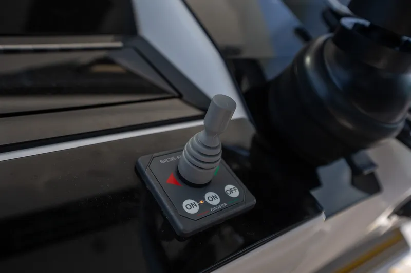 Slide: The Image of Joystick control panel on 2025 Deep Impact 369 Sport boat, featuring on/off thruster switch. - 19
