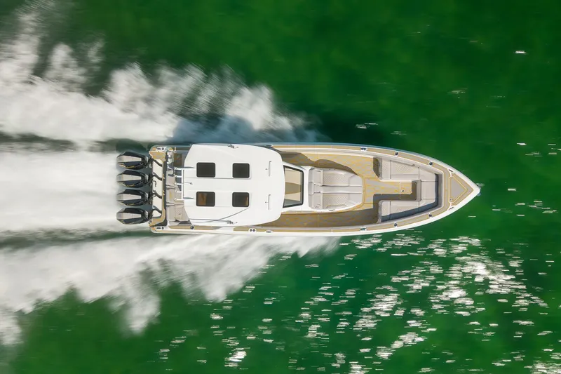 Slide: The Image of Aerial view of 2025 Deep Impact 369 Sport boat speeding on green water. - 9