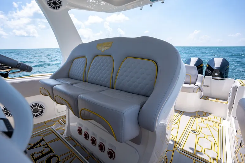 Slide: The Image of Luxury seating on 2025 Deep Impact 369 Sport boat with ocean backdrop. - 14