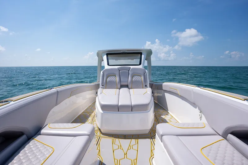 Slide: The Image of 2025 Deep Impact 369 Sport boat interior with luxurious seating on open water. - 12