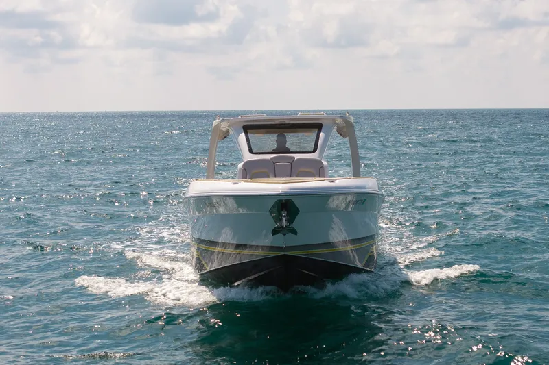 Slide: The Image of 2025 Deep Impact 369 Sport boat cruising on open water under a cloudy sky. - 8