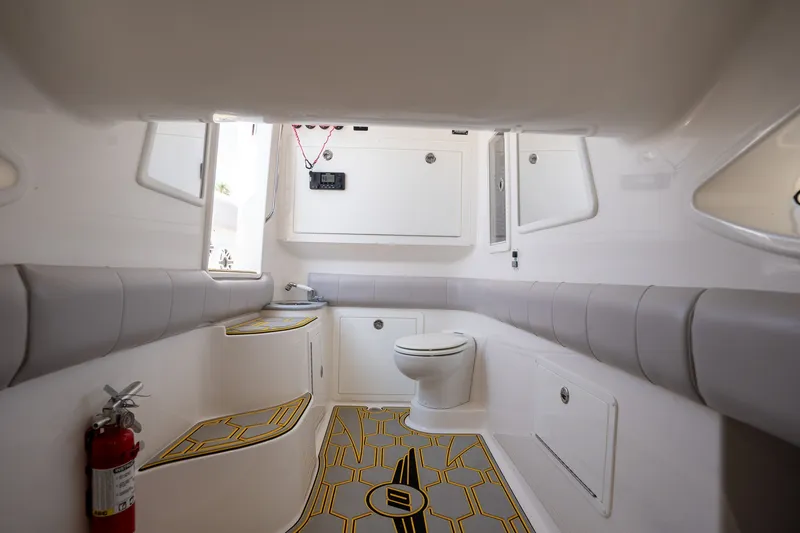 Slide: The Image of Interior of 2025 Deep Impact 369 Sport boat, featuring modern bathroom amenities. - 26