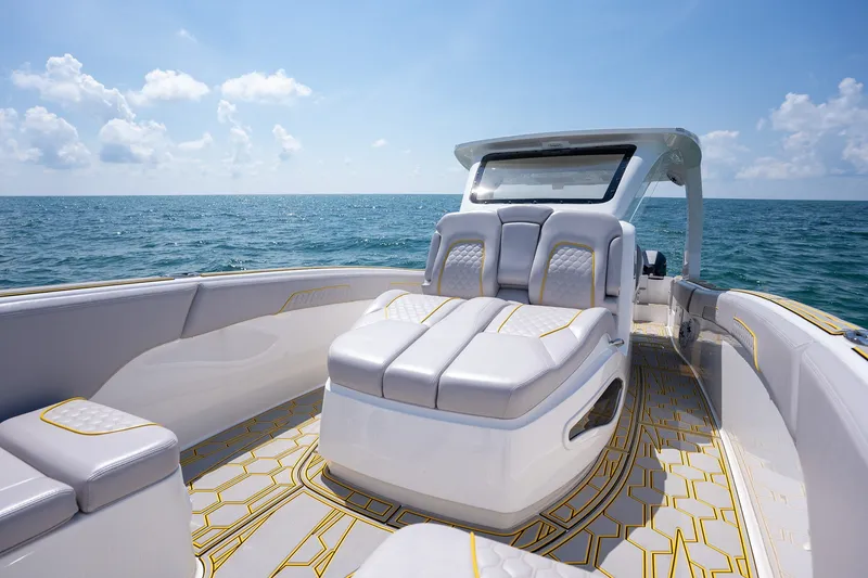 Slide: The Image of Luxury seating on 2025 Deep Impact 369 Sport boat, ocean backdrop, clear sky. - 13