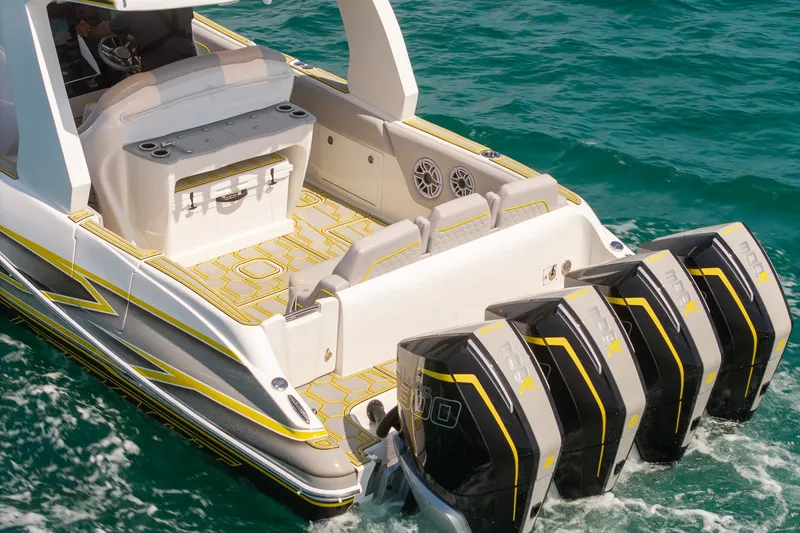 Slide: The Image of 2025 Deep Impact 369 Sport boat with four powerful outboard engines on turquoise water. - 11