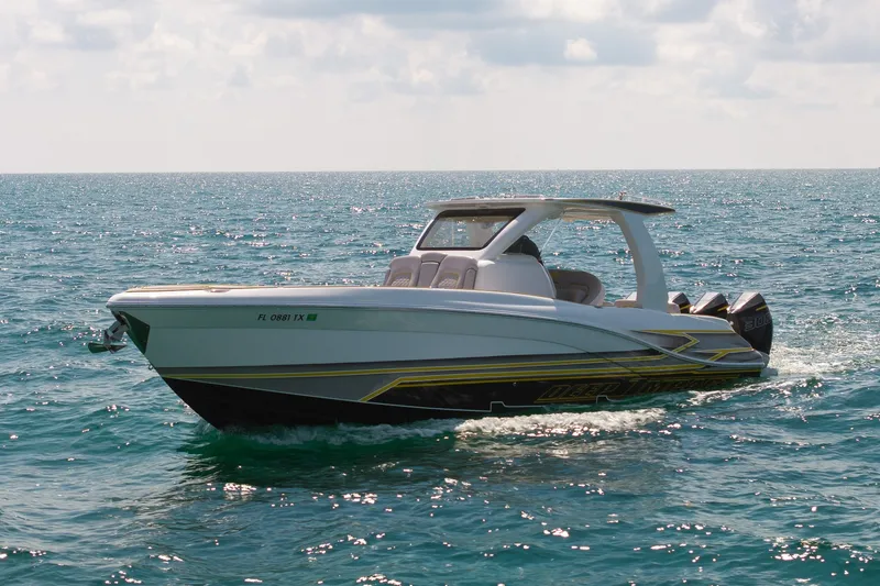 Slide: The Image of 2025 Deep Impact 369 Sport boat cruising on open water under a cloudy sky. - 4