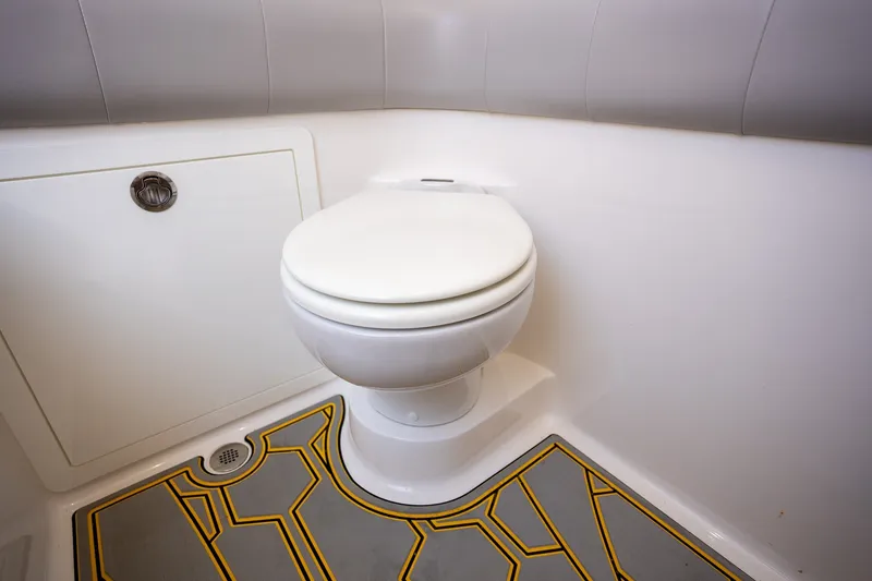 Slide: The Image of Modern marine toilet in 2025 Deep Impact 369 Sport boat, featuring sleek design and patterned flooring. - 28