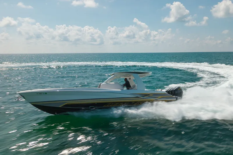 Slide: The Image of 2025 Deep Impact 369 Sport boat speeding on open ocean under clear skies. - 5