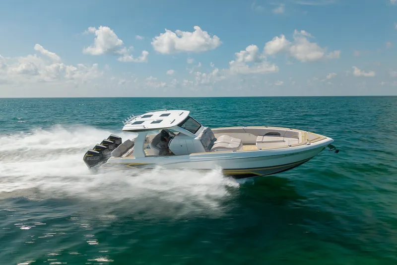 Slide: The Image of 2025 Deep Impact 369 Sport boat speeding on open ocean under clear skies. - 3
