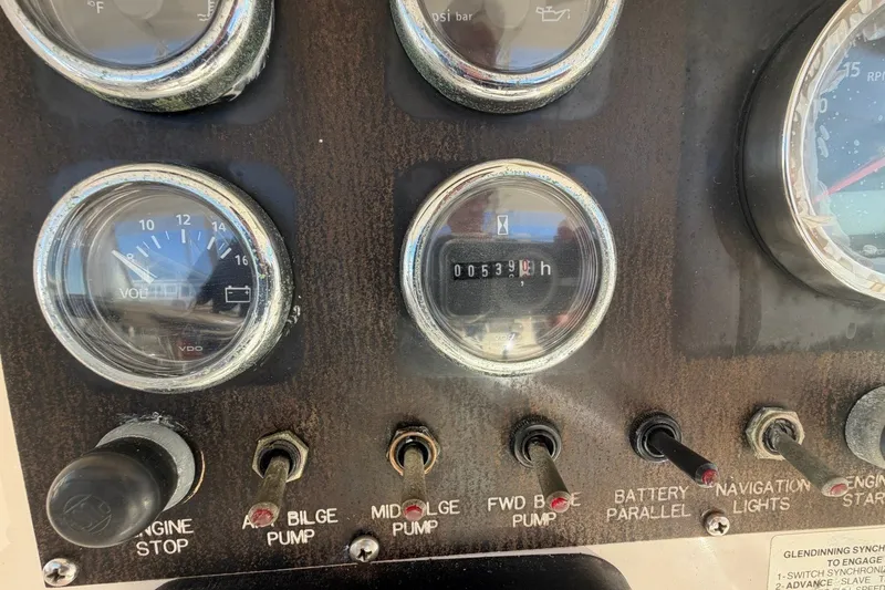 Slide: The Image of Control panel of a 1990 Viking 44 Motor Yacht with gauges and switches. - 28